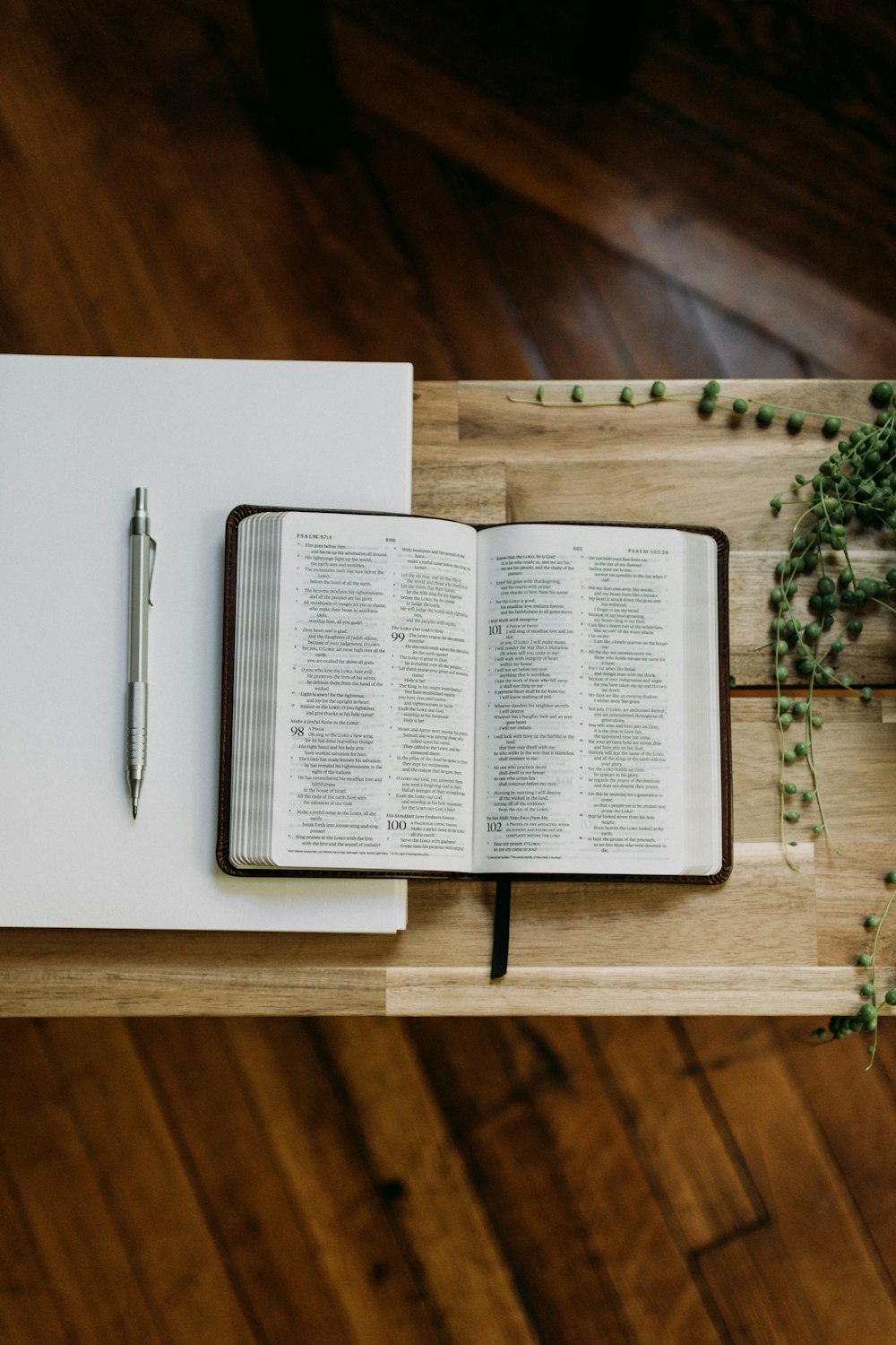 an open book with a pen on top of it