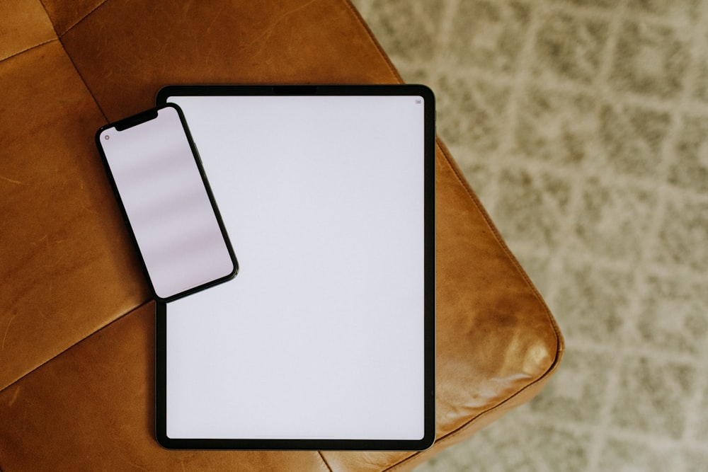 a clipboard sitting on top of a brown leather chair