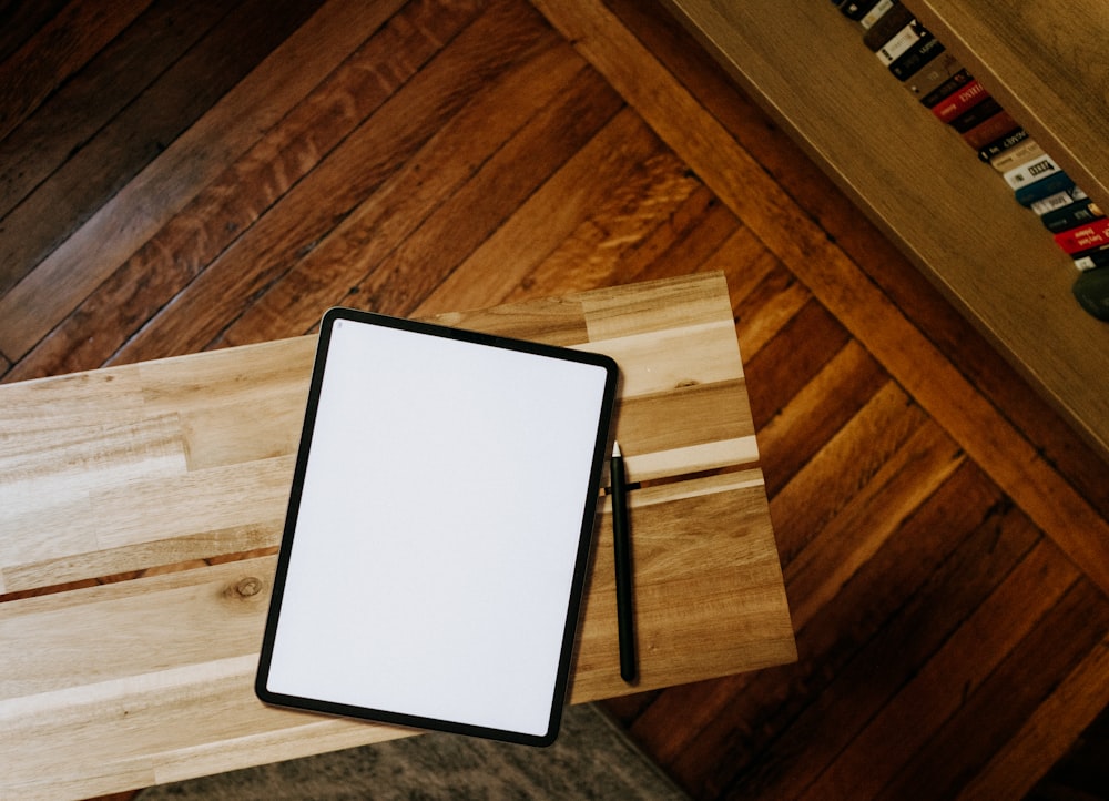 an overhead view of a wooden table with a white board
