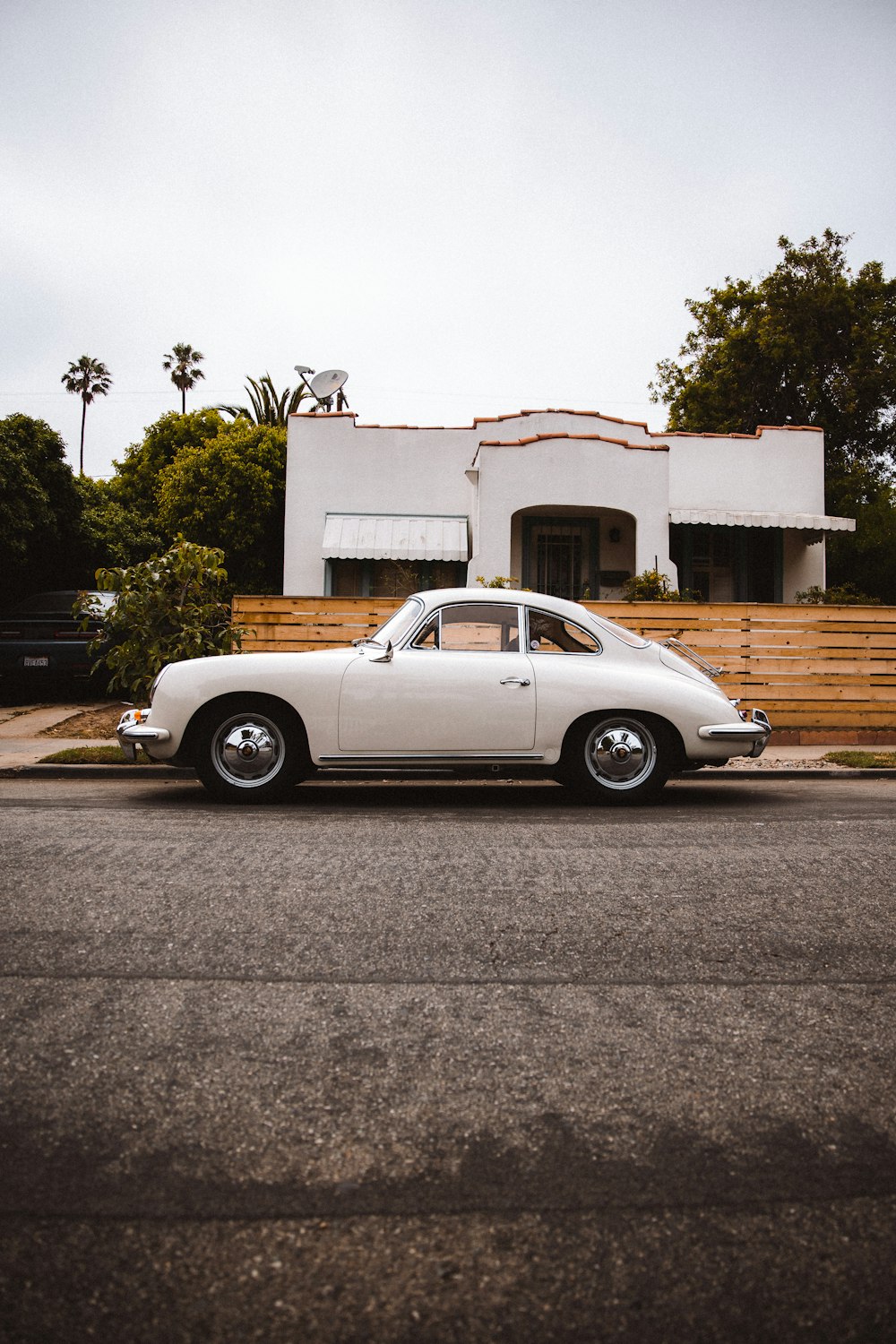 a white car parked in front of a house