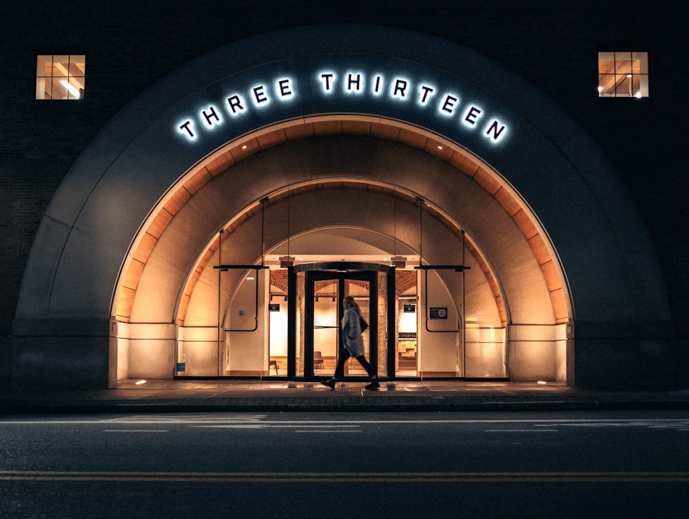 a man walking out of a tunnel into a building