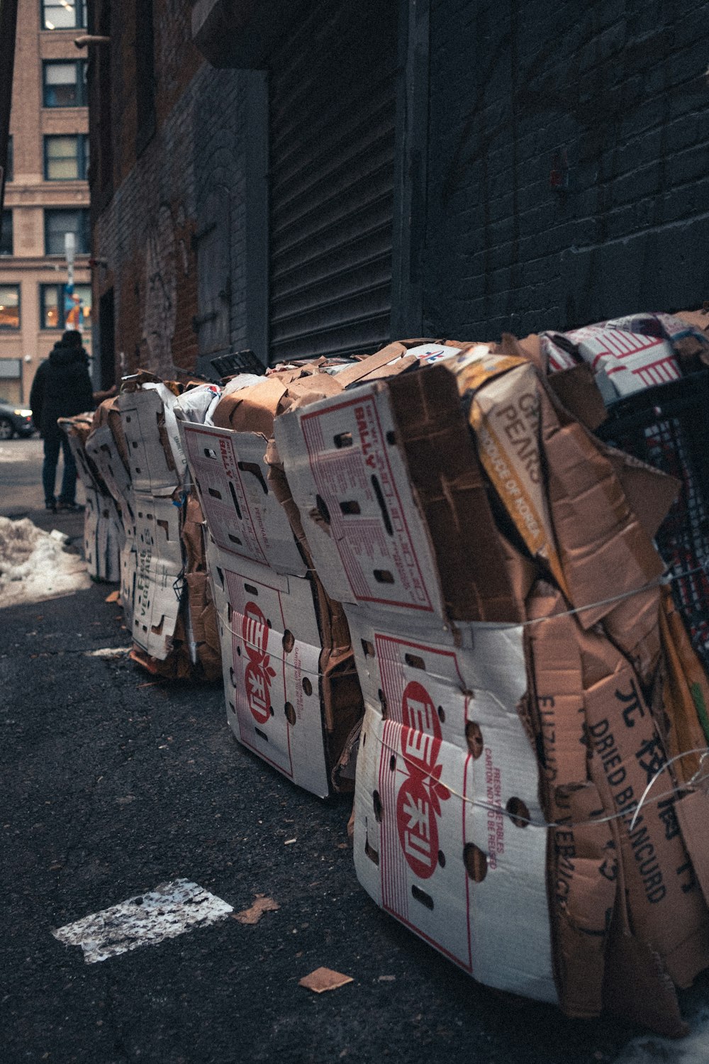 a pile of boxes sitting on the side of a road