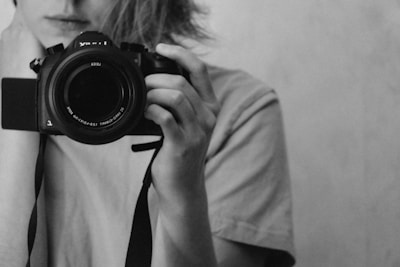 a woman taking a picture of herself with a camera