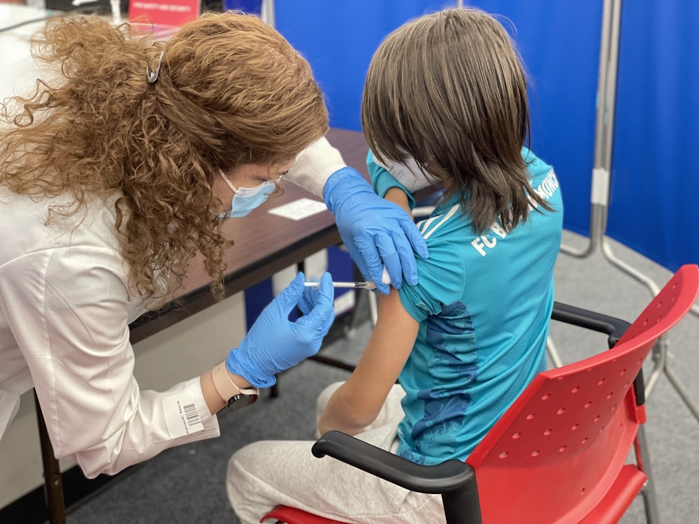 a woman getting her teeth checked by a dentist