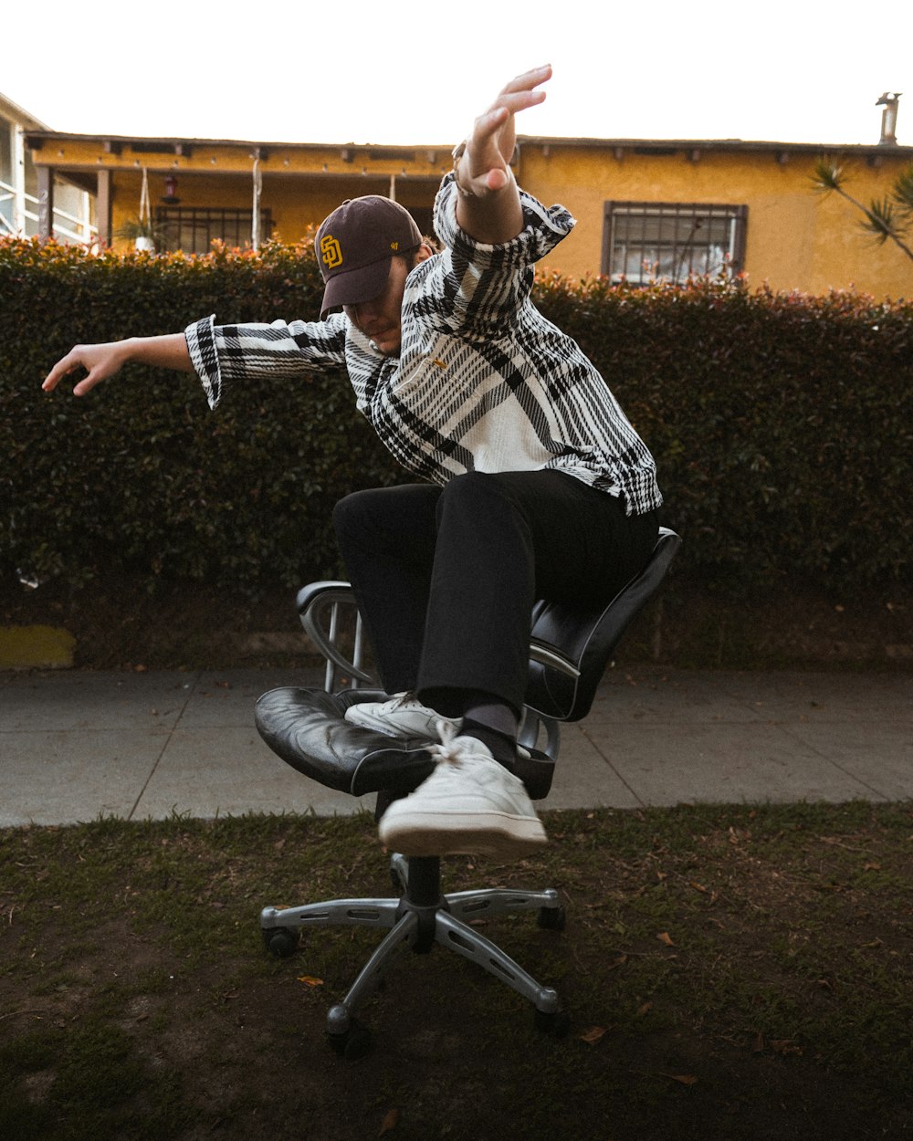 a man is doing a trick on a chair