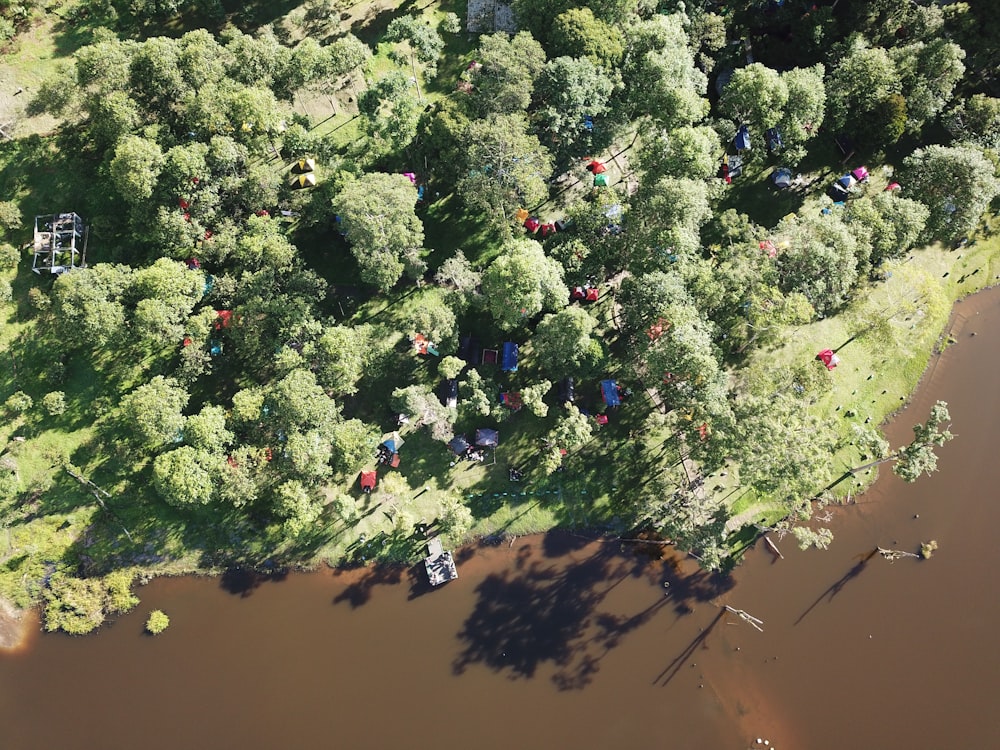 an aerial view of a wooded area next to a river