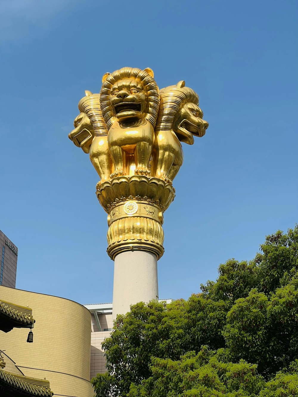 a golden statue of a lion on top of a building