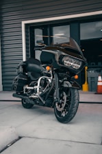 A motorcycle parked outside a modern office building ready for delivery.