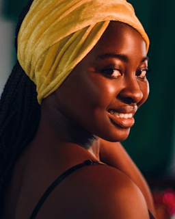 a woman with a yellow towel on her head