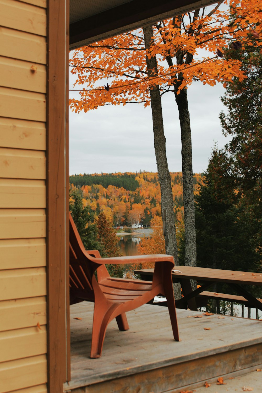 a wooden chair sitting on top of a wooden deck