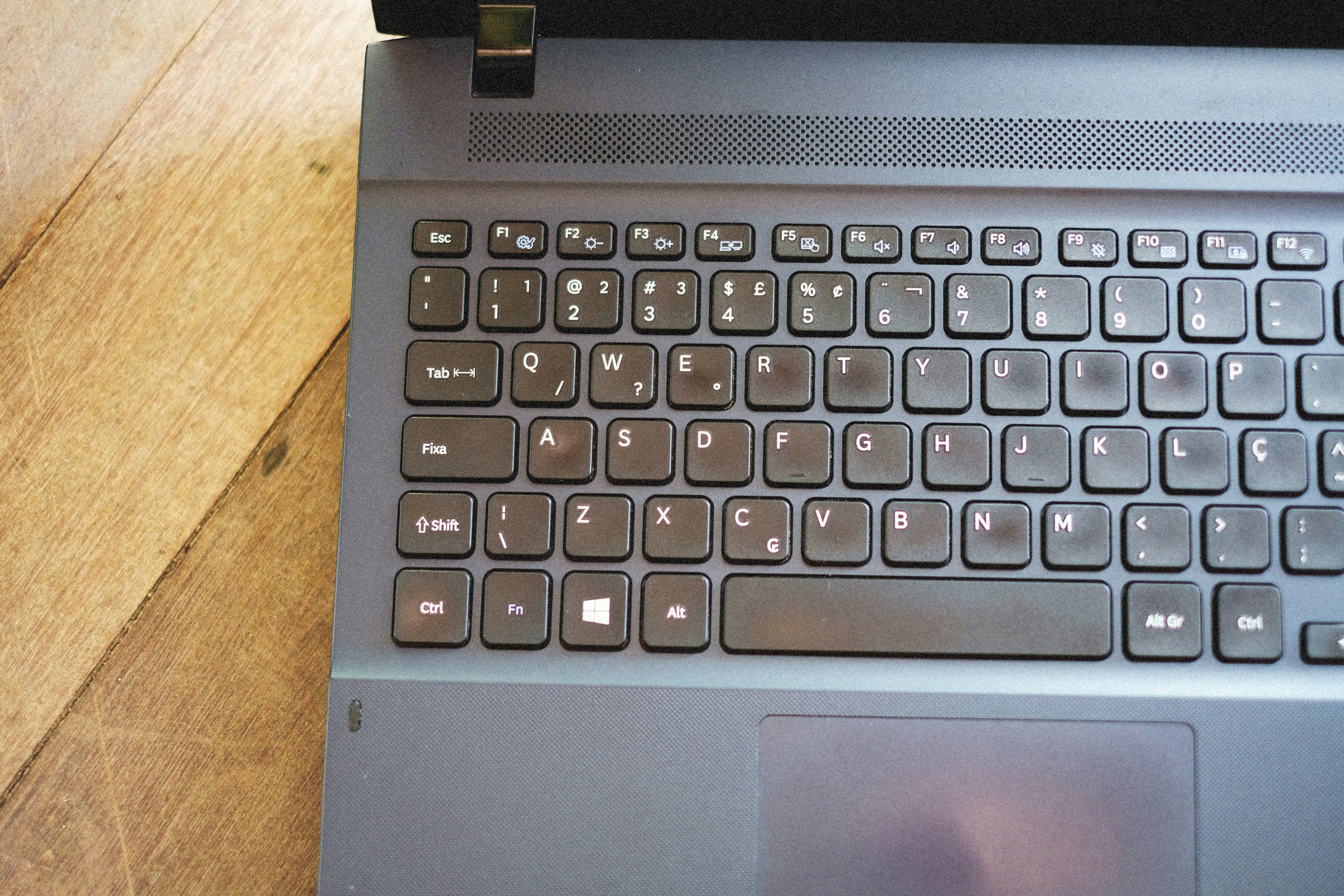 a laptop computer sitting on top of a wooden table