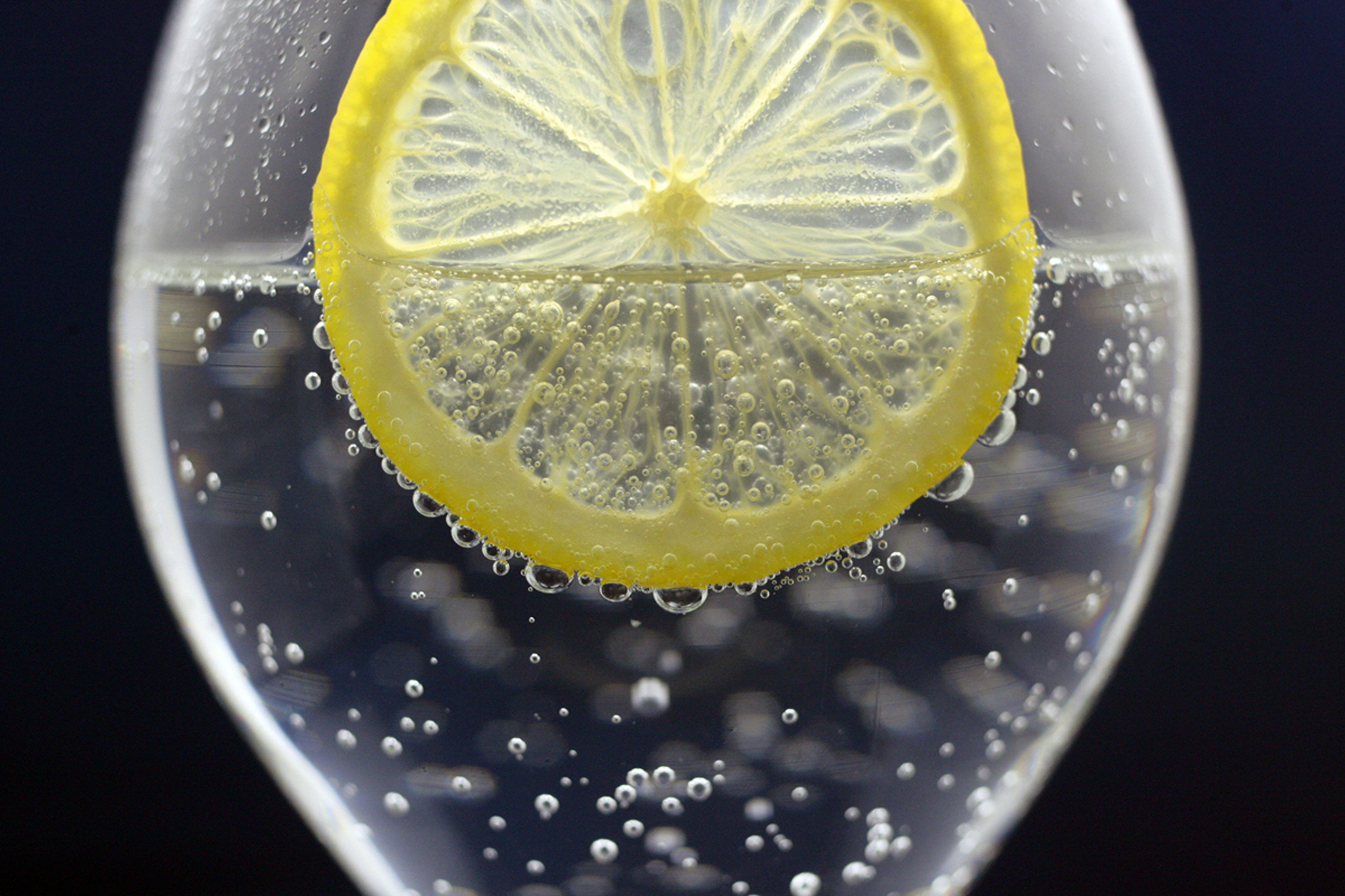 a glass of water with a lemon slice in it