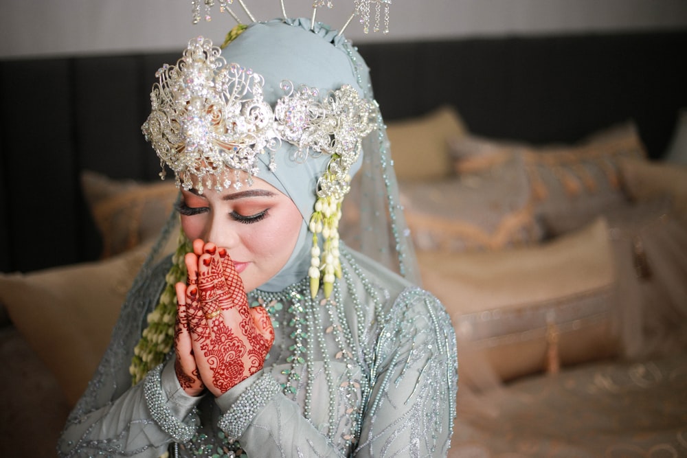 a woman in a blue dress holding a piece of food