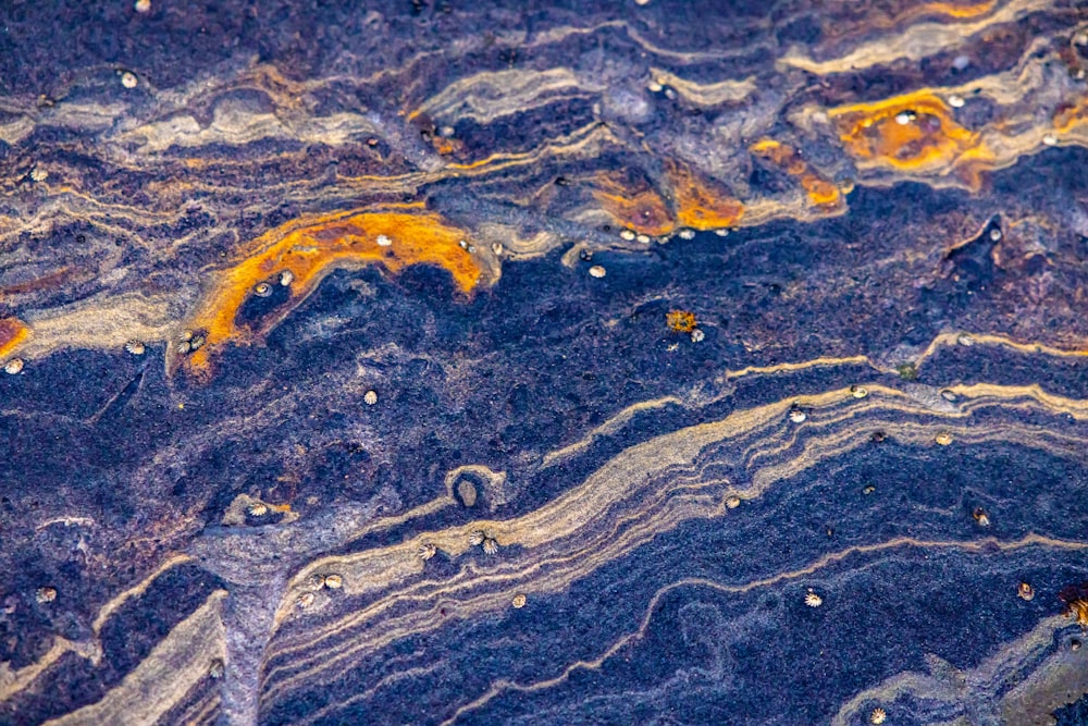 a close up of a blue and yellow marble