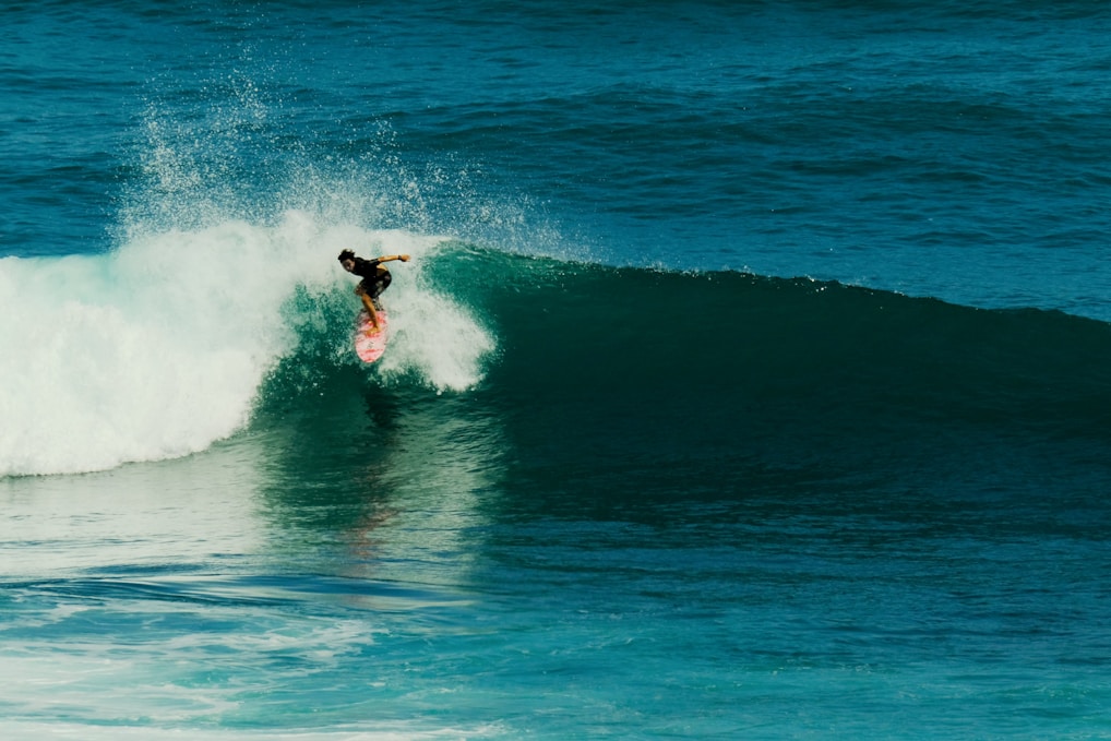 a person on a surfboard riding a wave