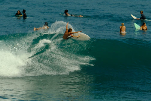 a person riding a surfboard on a wave in the ocean