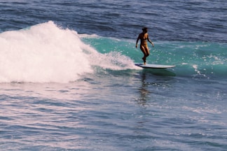 a person riding a surf board on a wave
