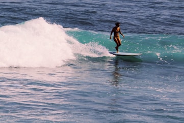 a person riding a surf board on a wave