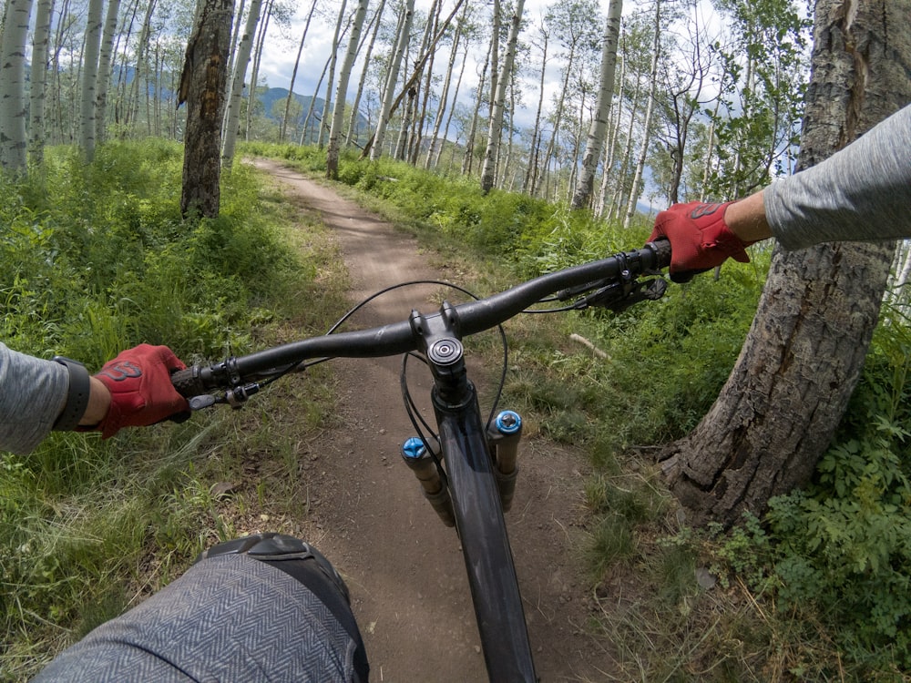 a person riding a bike down a dirt road