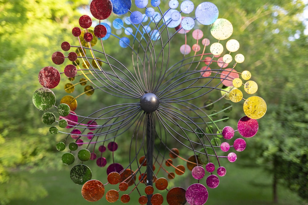 a colorful wind chime hanging from a tree