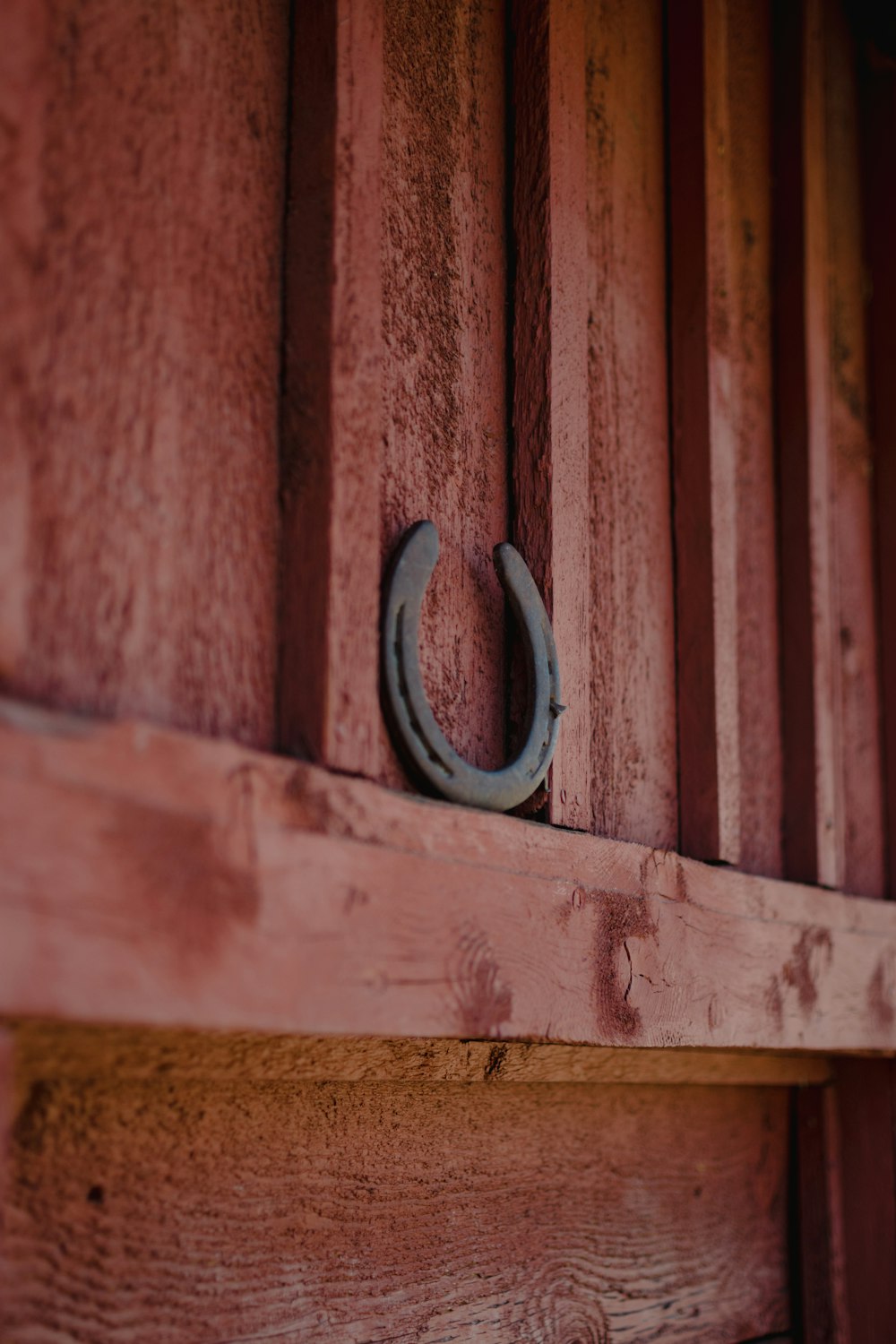 a wooden door with a metal hook on it