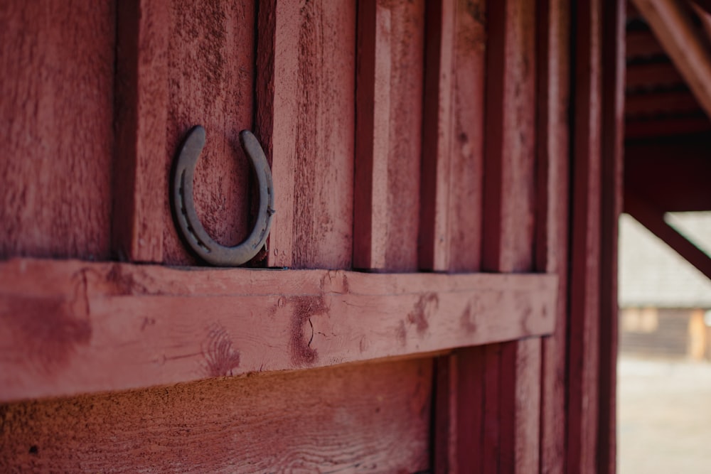 a close up of a wooden door with a metal ring on it