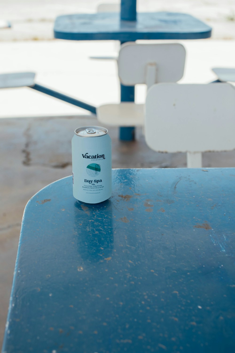 a can of soda sitting on top of a blue table