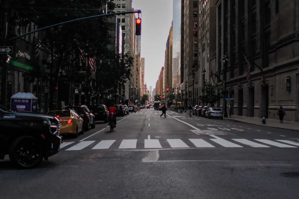 a city street filled with lots of traffic and tall buildings