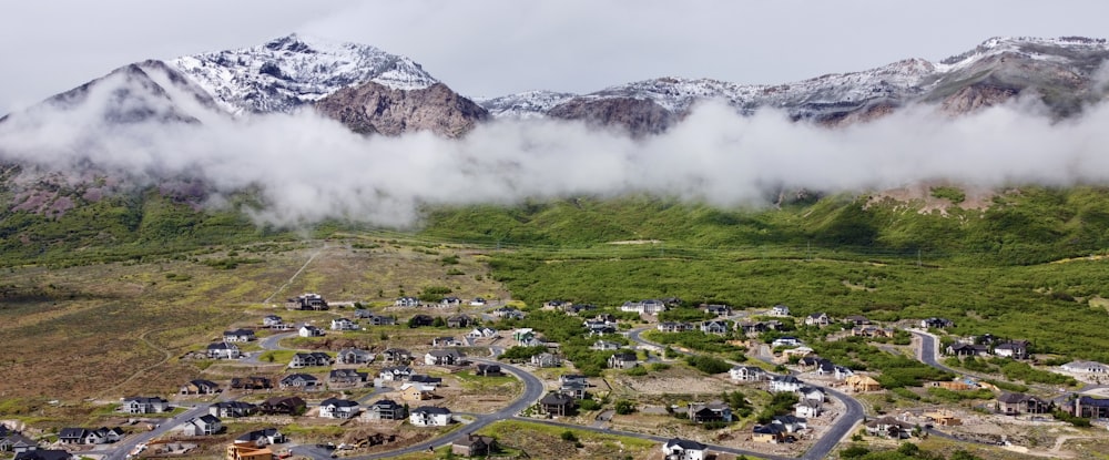 an aerial view of a town surrounded by mountains