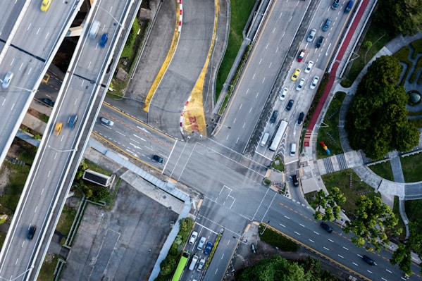 an aerial view of an intersection with cars and trucks