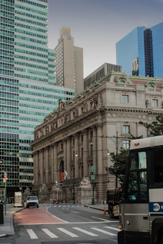 a bus driving down a street next to tall buildings