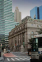 a bus driving down a street next to tall buildings