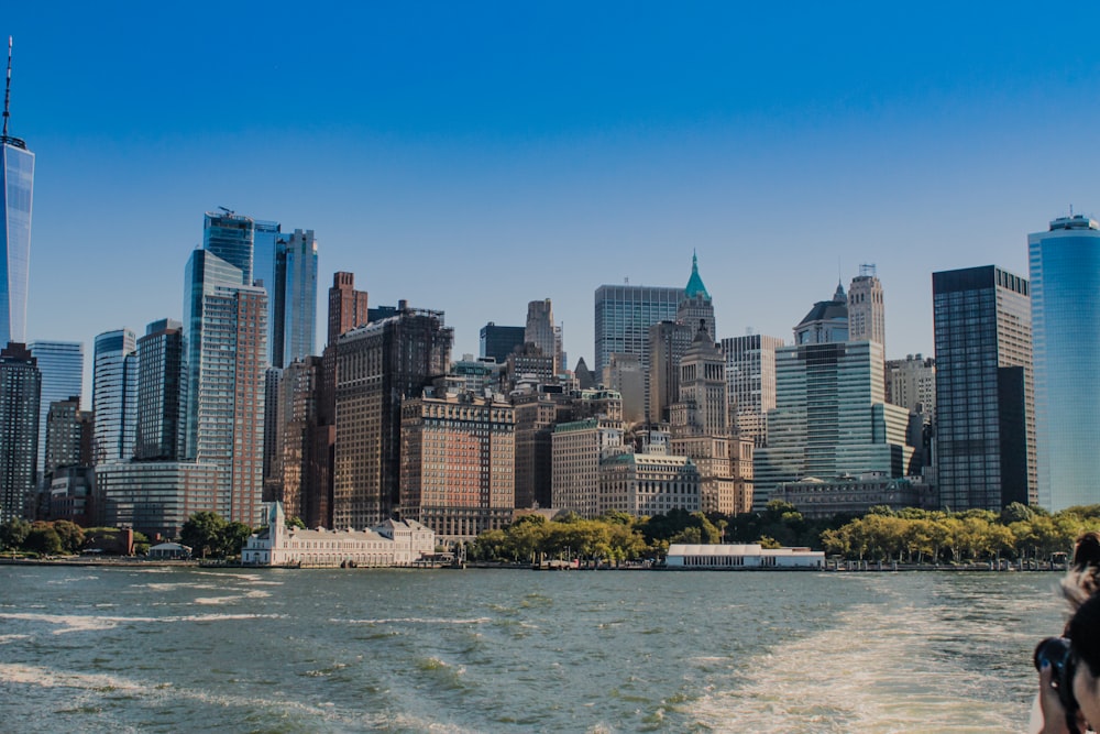 a boat traveling down a river next to tall buildings