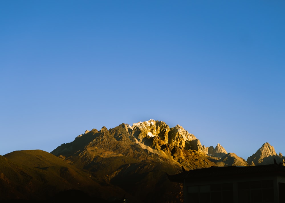 a view of a mountain with a house in the foreground