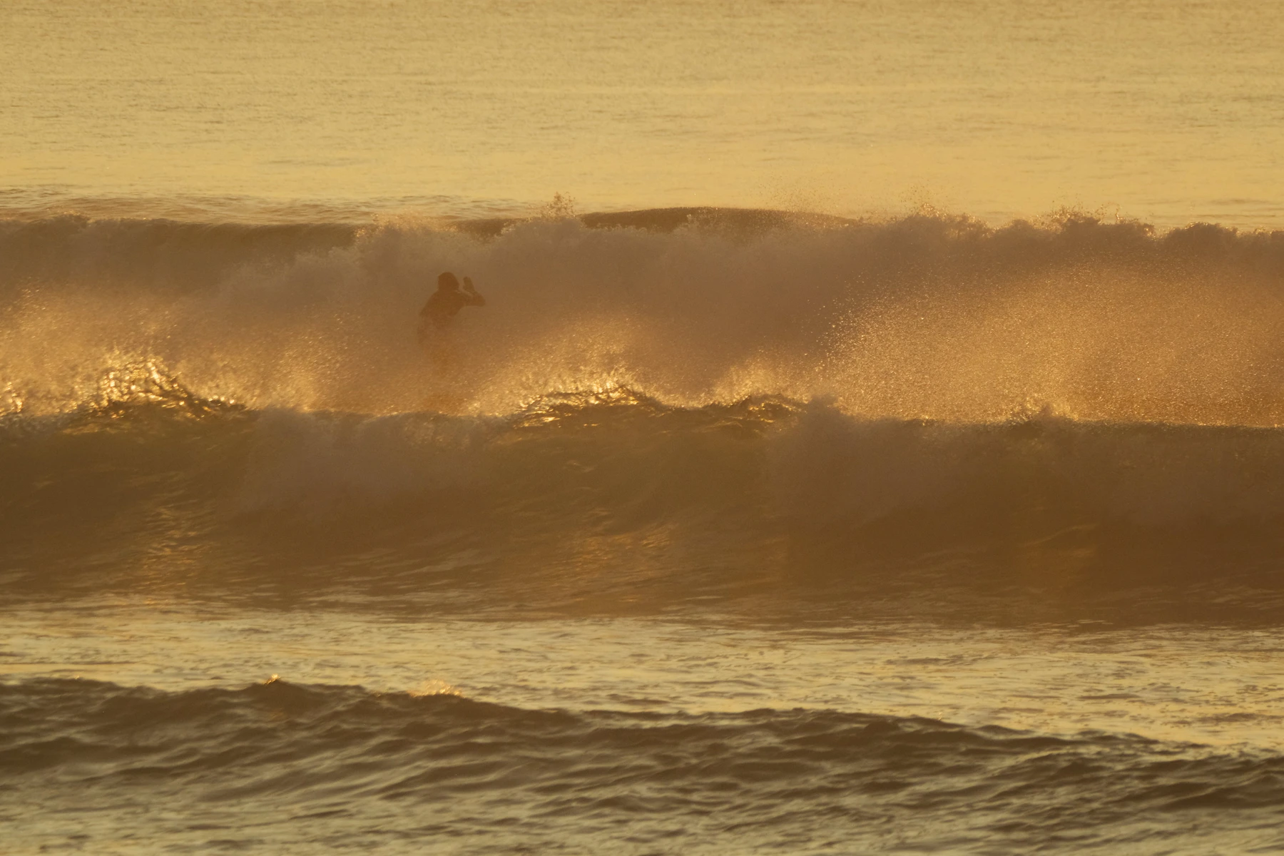 Surfers sharing a clean tropical wave with space and control