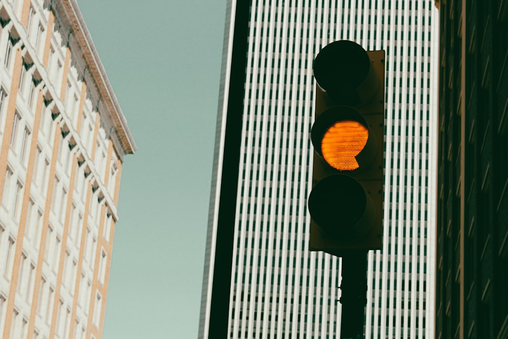 a traffic light in front of a tall building