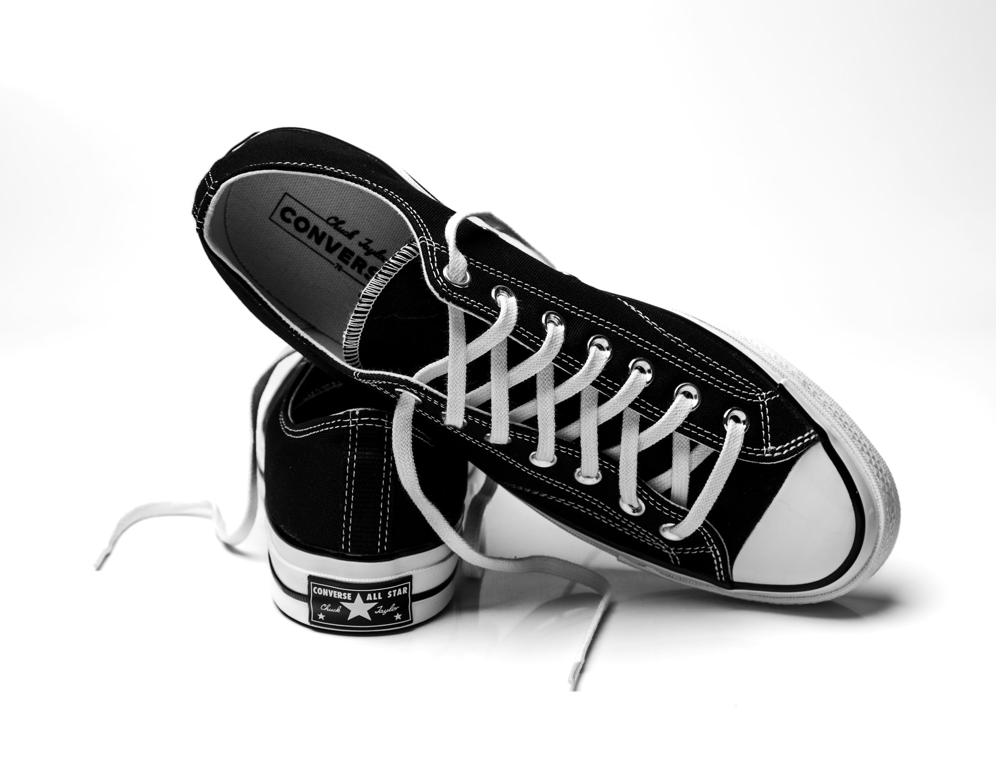 Black and white photo of converse Chuck Taylors. 