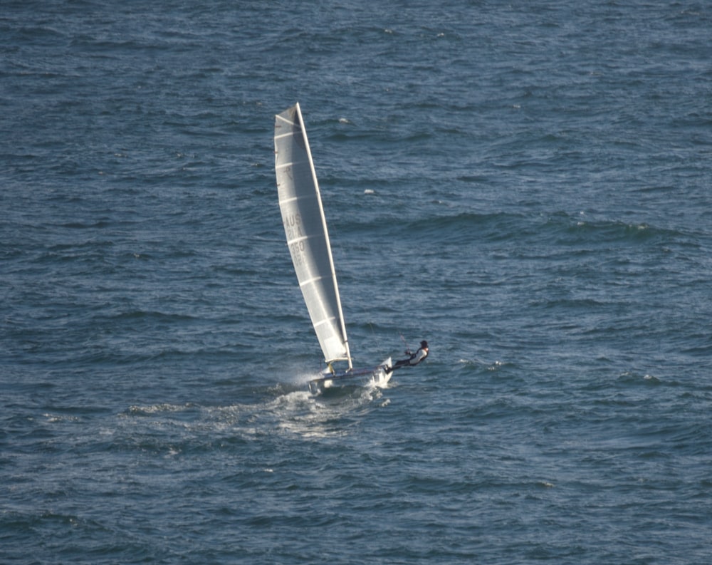 a person riding a sail boat on a body of water