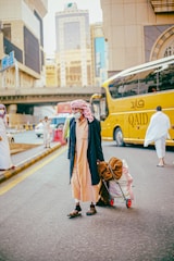 a man pulling a luggage cart down a street