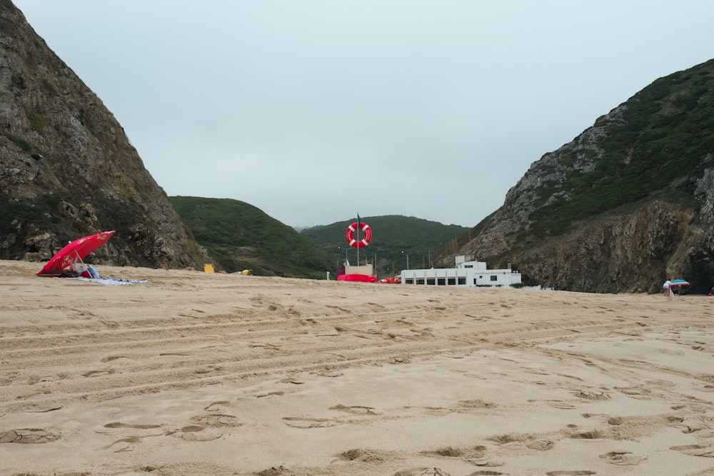 a couple of umbrellas that are in the sand