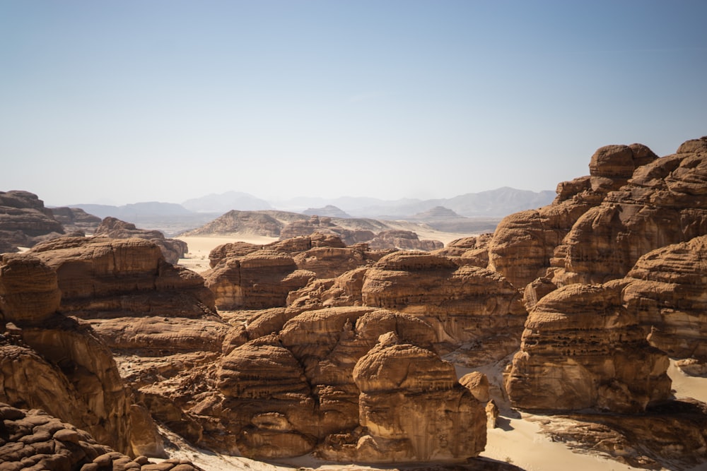 a desert landscape with rocks and mountains in the background