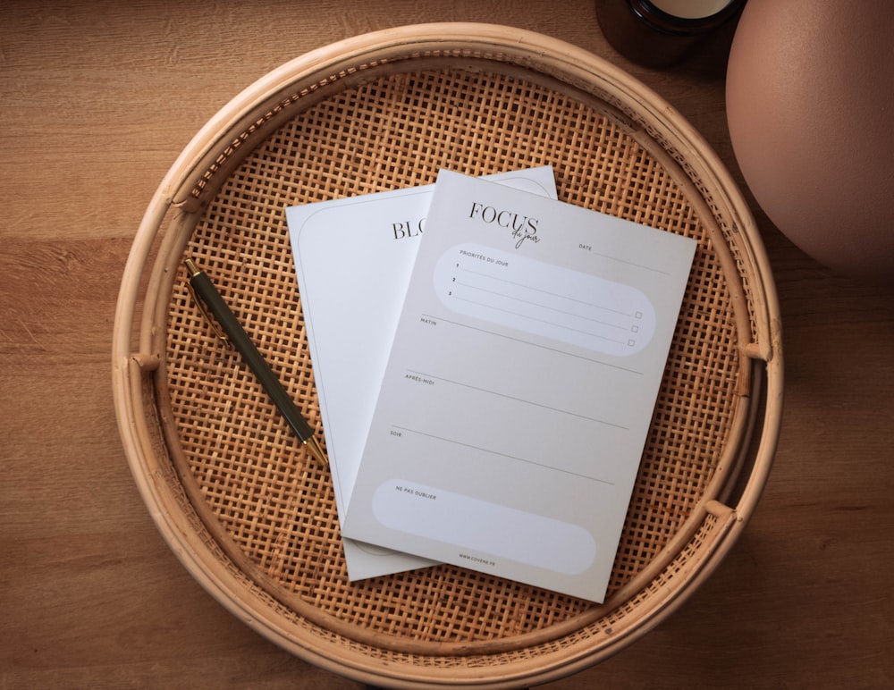 a couple of papers sitting on top of a wooden table