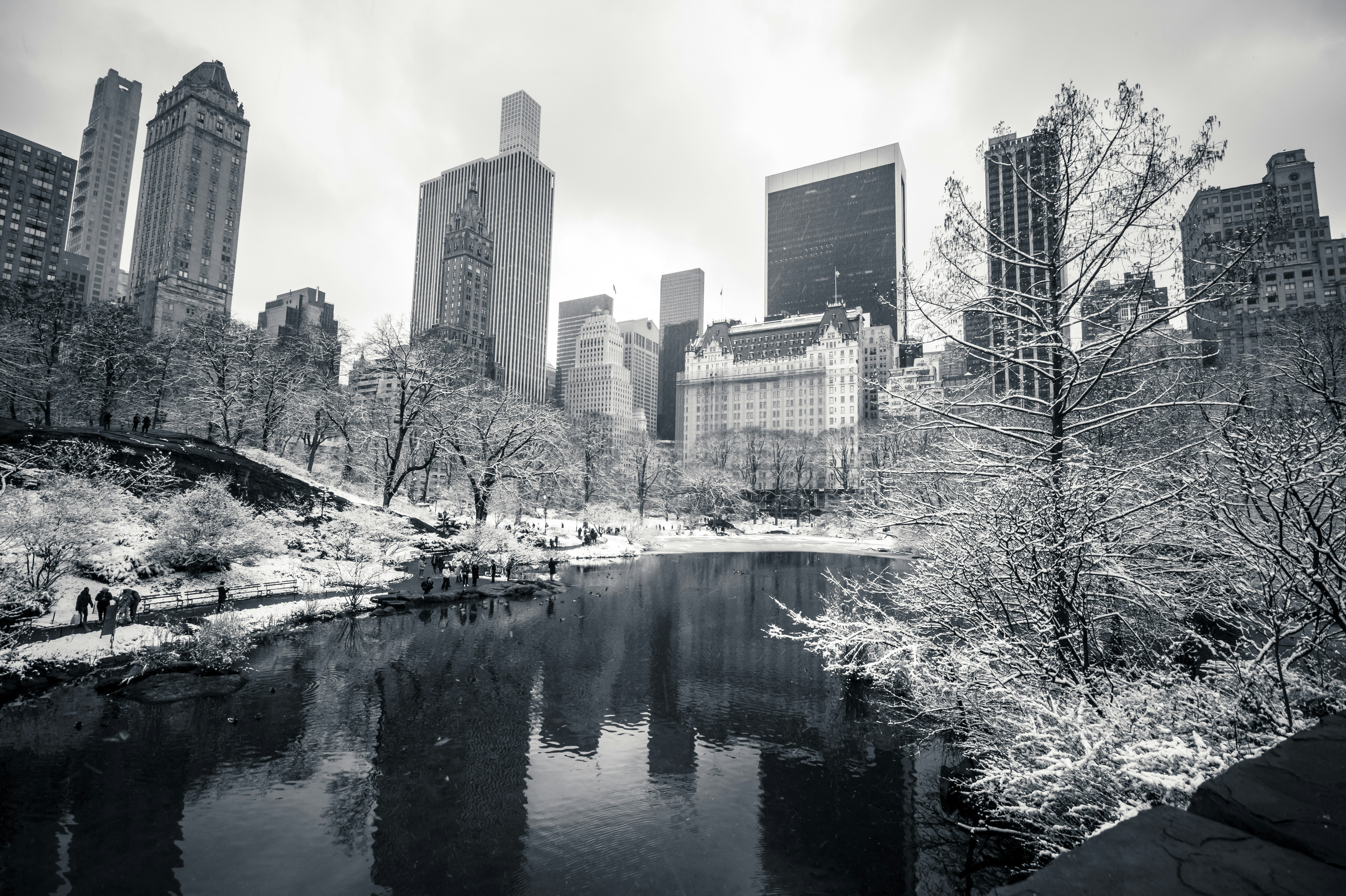 a black and white photo of a river in a city