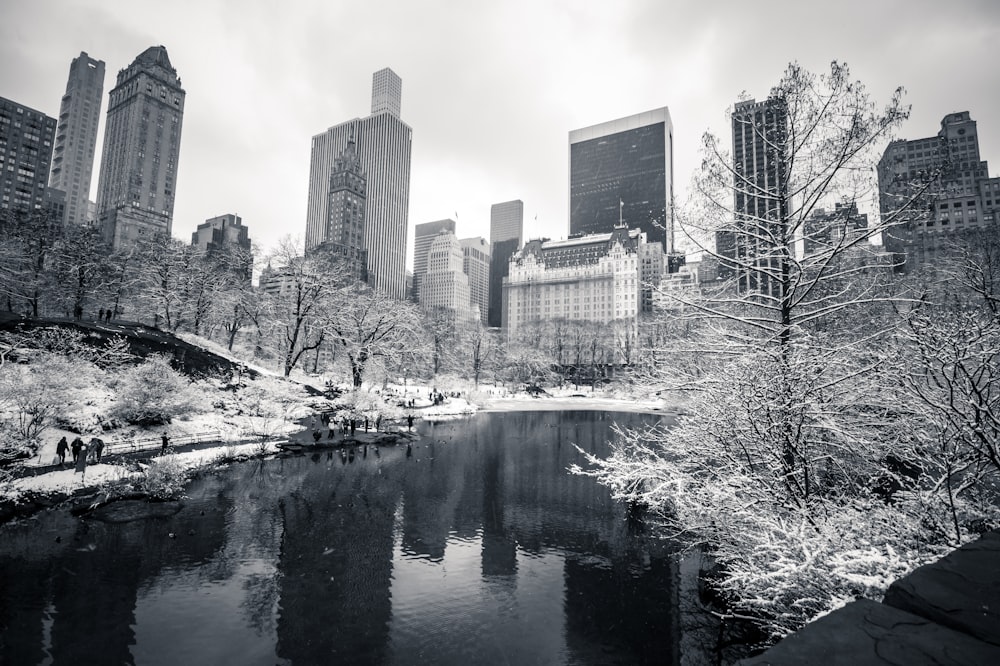 a black and white photo of a river in a city