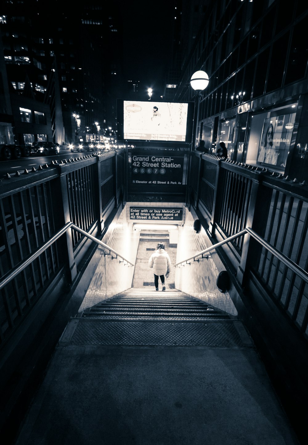 a man walking down a flight of stairs at night