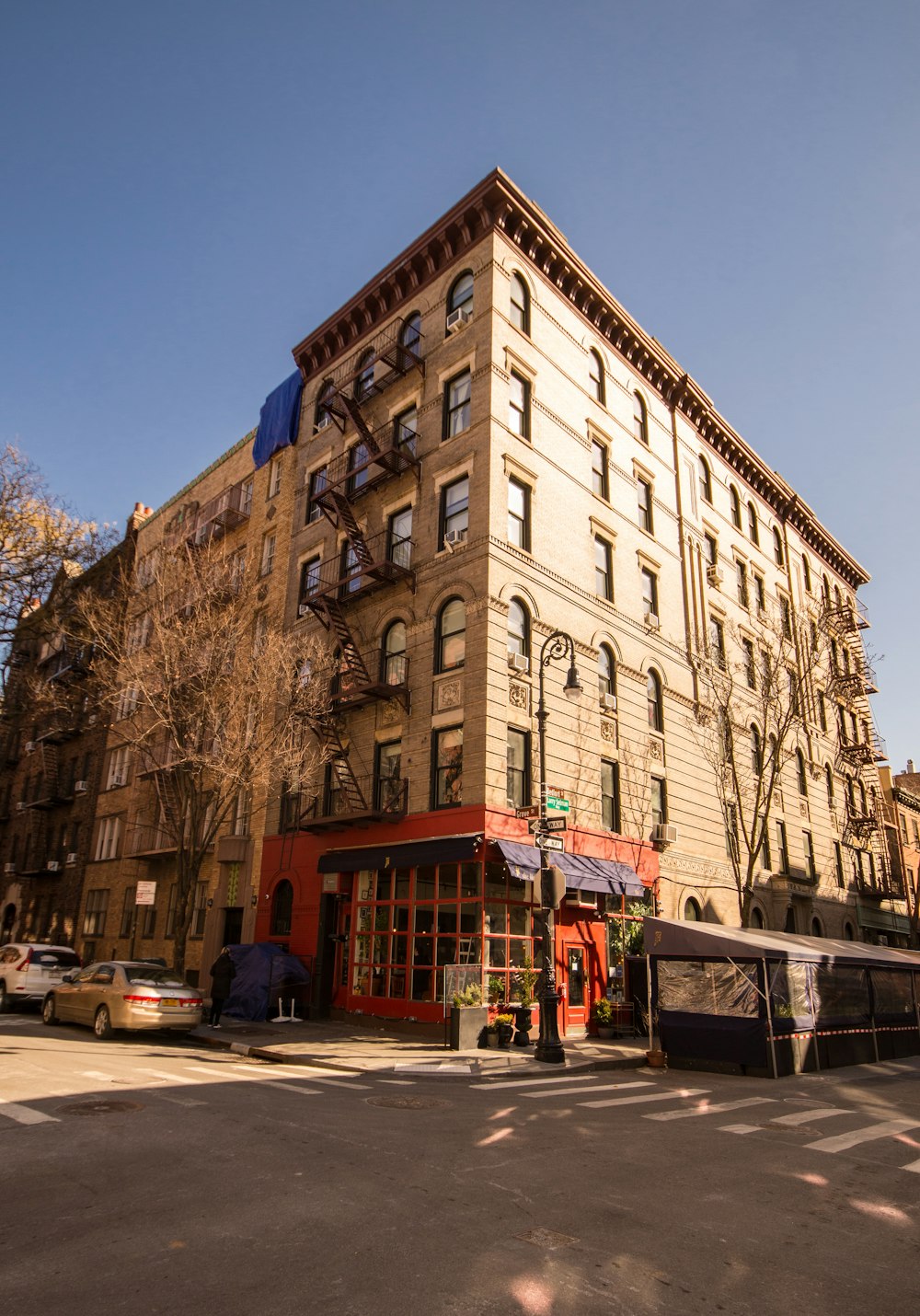 a large brown building with many windows next to a street