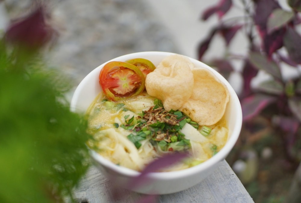 a bowl of food on a wooden table