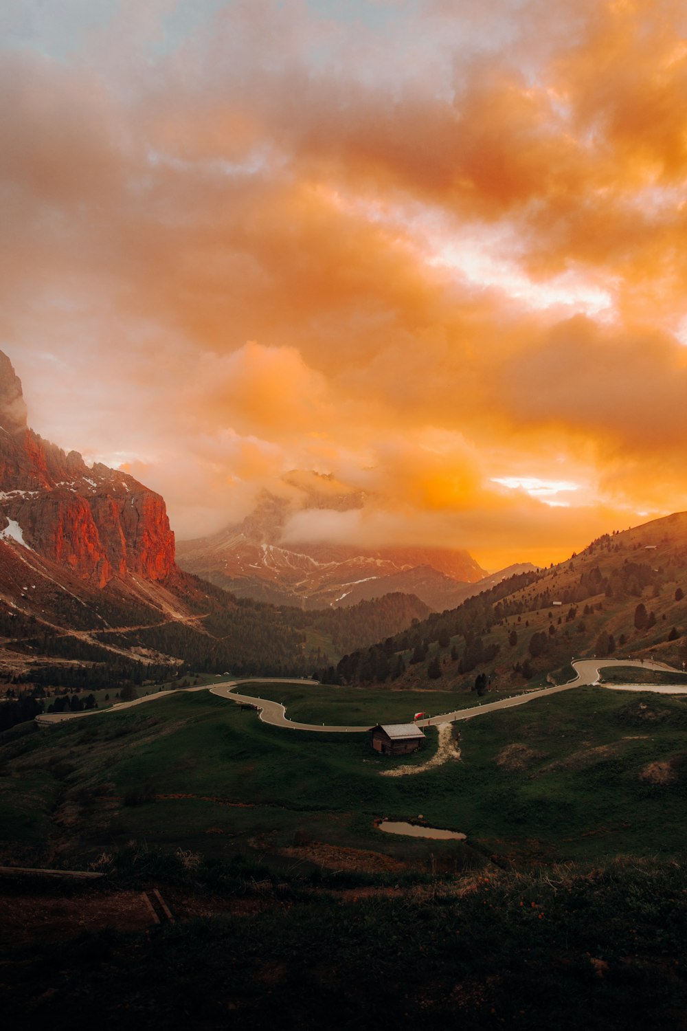 a scenic view of a valley with a mountain in the background