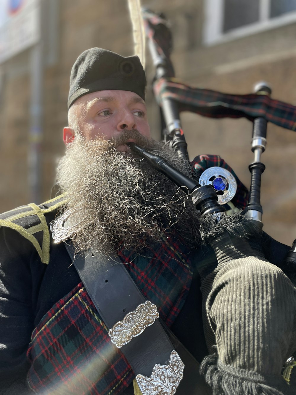 a man with a long beard playing a bagpipe