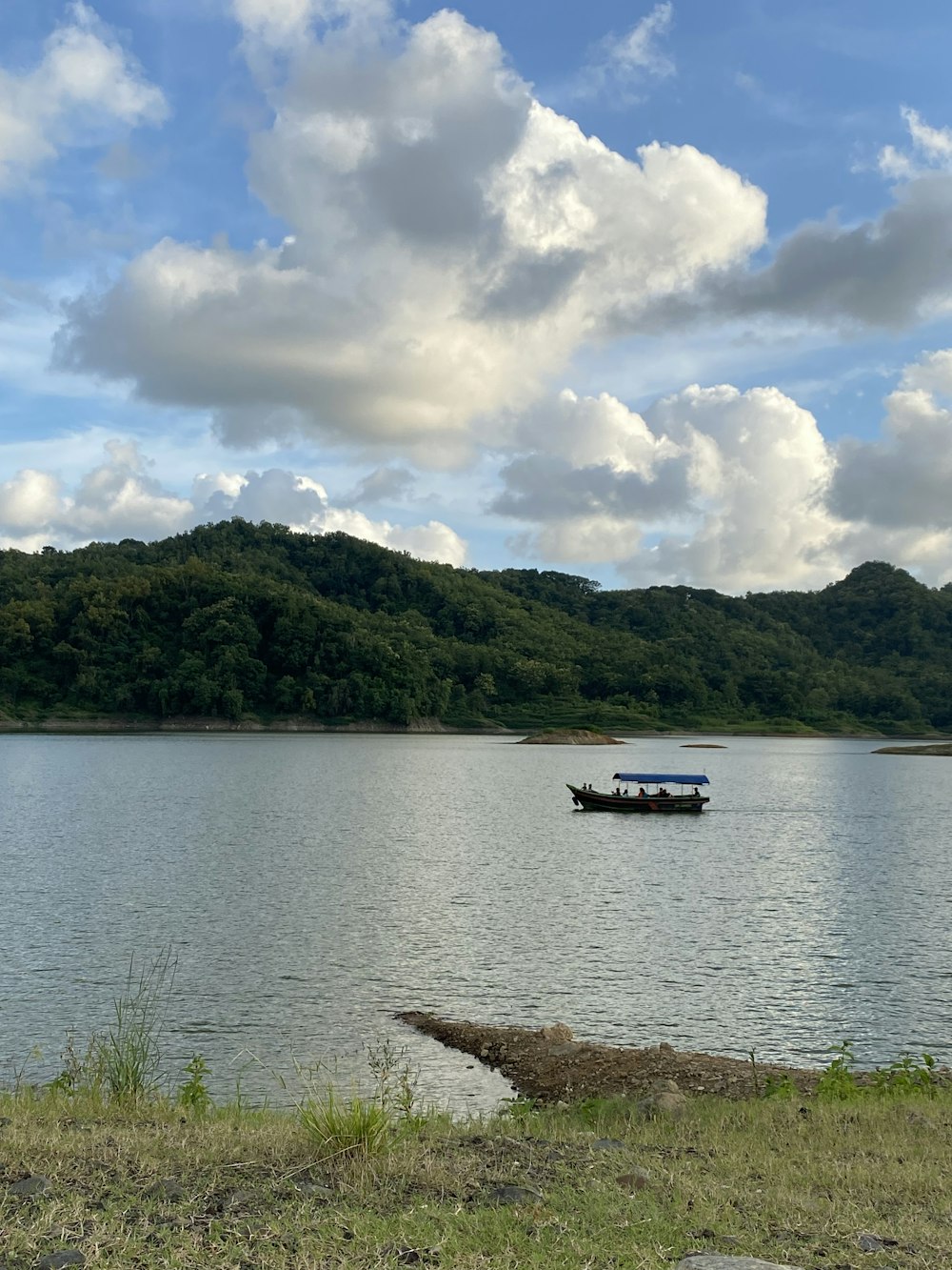 a small boat floating on top of a large body of water